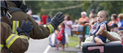 Fire Fighters waving at baby